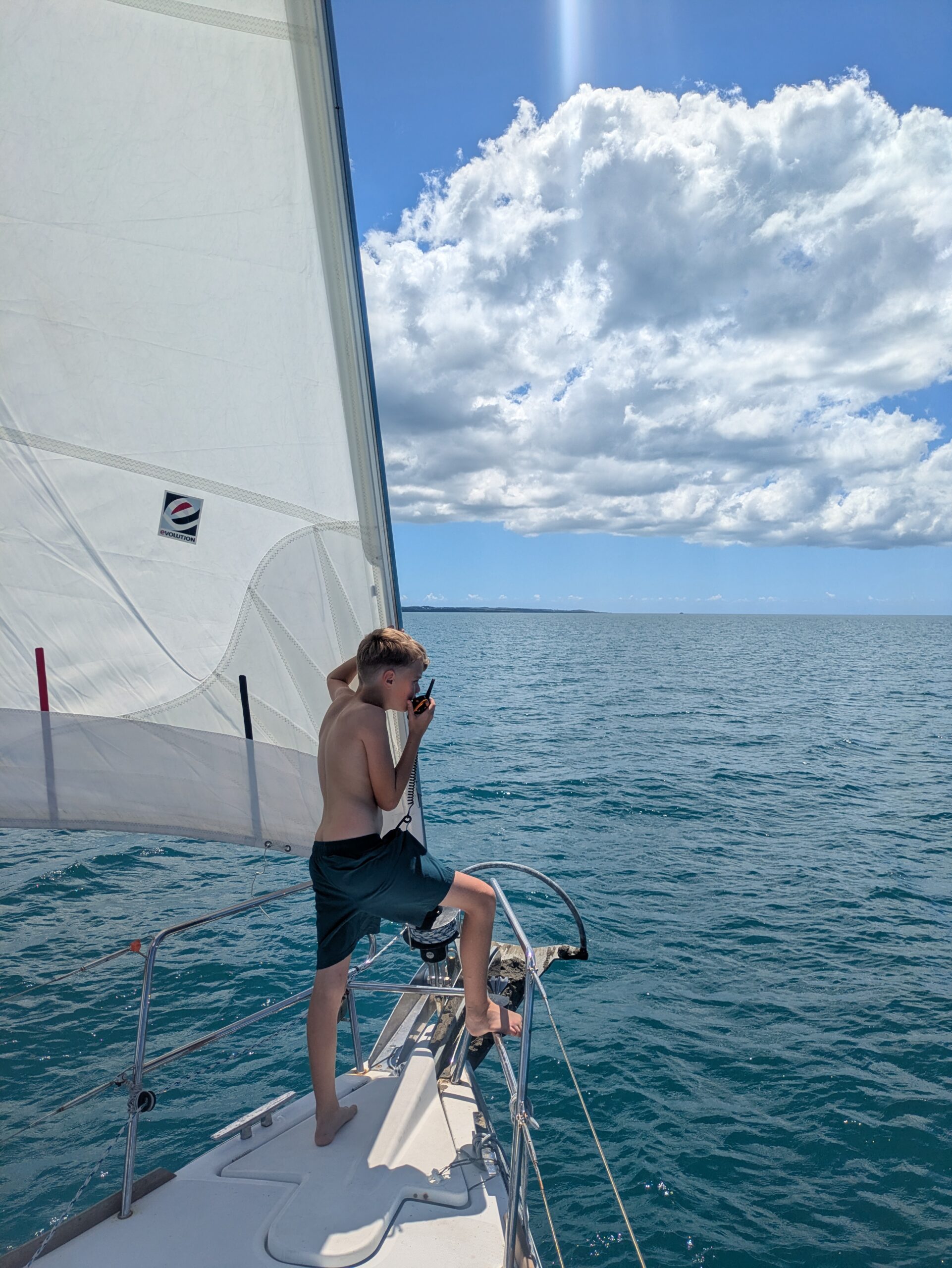 Corban looking out for fish traps on the foredeck.